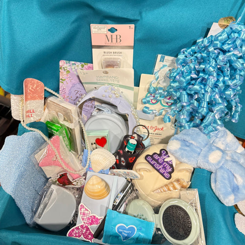Assortment of gift items displayed with blue ribbon for Sparkle Scoop